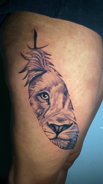 Surreal Photo-realism lion animal tattoo by Db. Wyte of Iron Palm Tattoos & Body Piercing. We love how the texture of the big cat's hair is rendered by the artist. Call 404-973-7828 or stop by for a free consultation to book DB. Wyte.