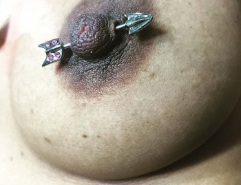 Bejeweled Arrow Nipple Piercing Jewelry Installed at Iron Palm Tattoos by an Iron Palm Body Piercer. Call 404-973-7828 or stop by for a free consultation with an body artist. Walk Ins are welcome.