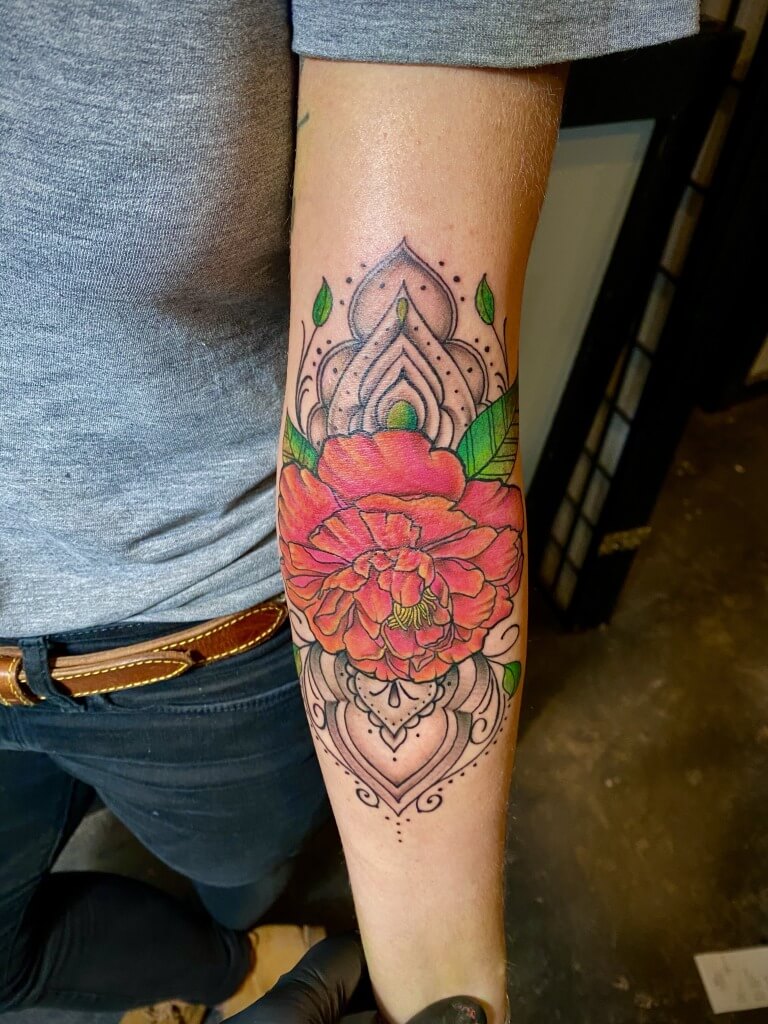 Beautiful Red Rose Floral Tattoo On the Elbow By Lyric The Artist At Iron Palm Tattoos in south downtown Atlanta, Georgia. One of Lyrics' special styles is rose tattoos. Call 404-973-7828 or stop by for a free consultation with Lyric. Walk Ins are welcome.