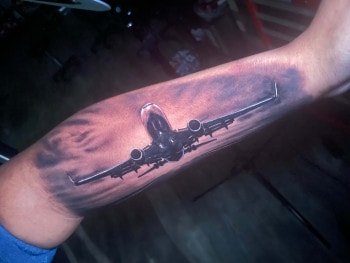 Commercial Jet Airline Colored Photo-realistic Tattoo by tattooist T Sawyer At Iron Palm Tattoos In Downtown Atlanta. Call 404-973-7828 or stop by for a free consultation.