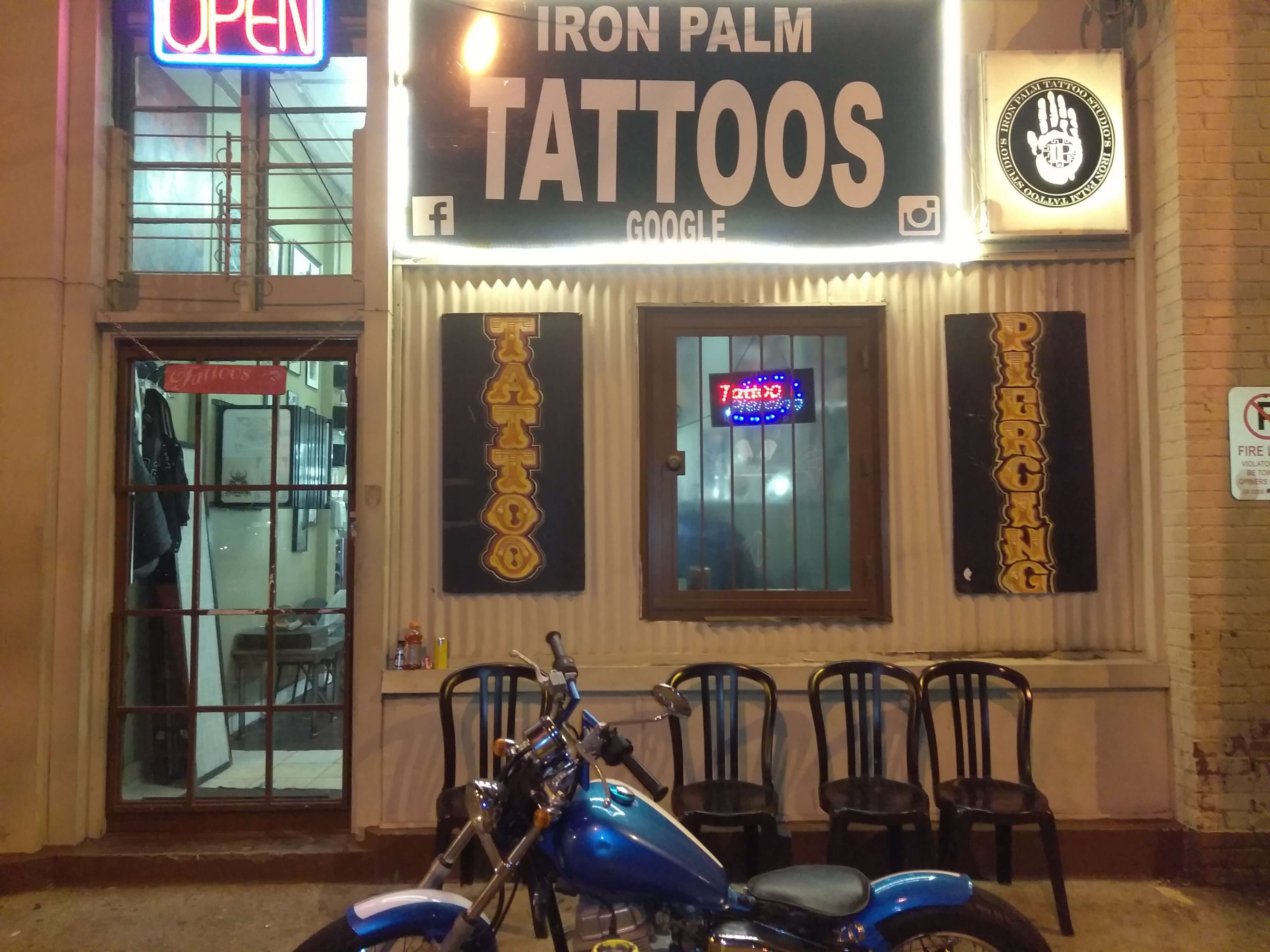 Front entrance exterior view of Iron Palm Tattoos & Body Piercing In Atlanta, Marlon's motorcycle is visible. Georgia. Iron Palm is know to have the best multi-style tattoo artists in Georgia.