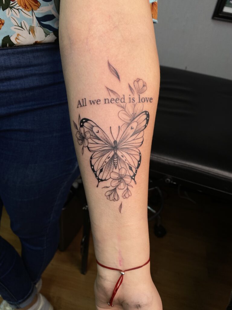 'All We Need Is Love' Fine Line Butterfly & Lettering Tattoo By Rene Cristobal