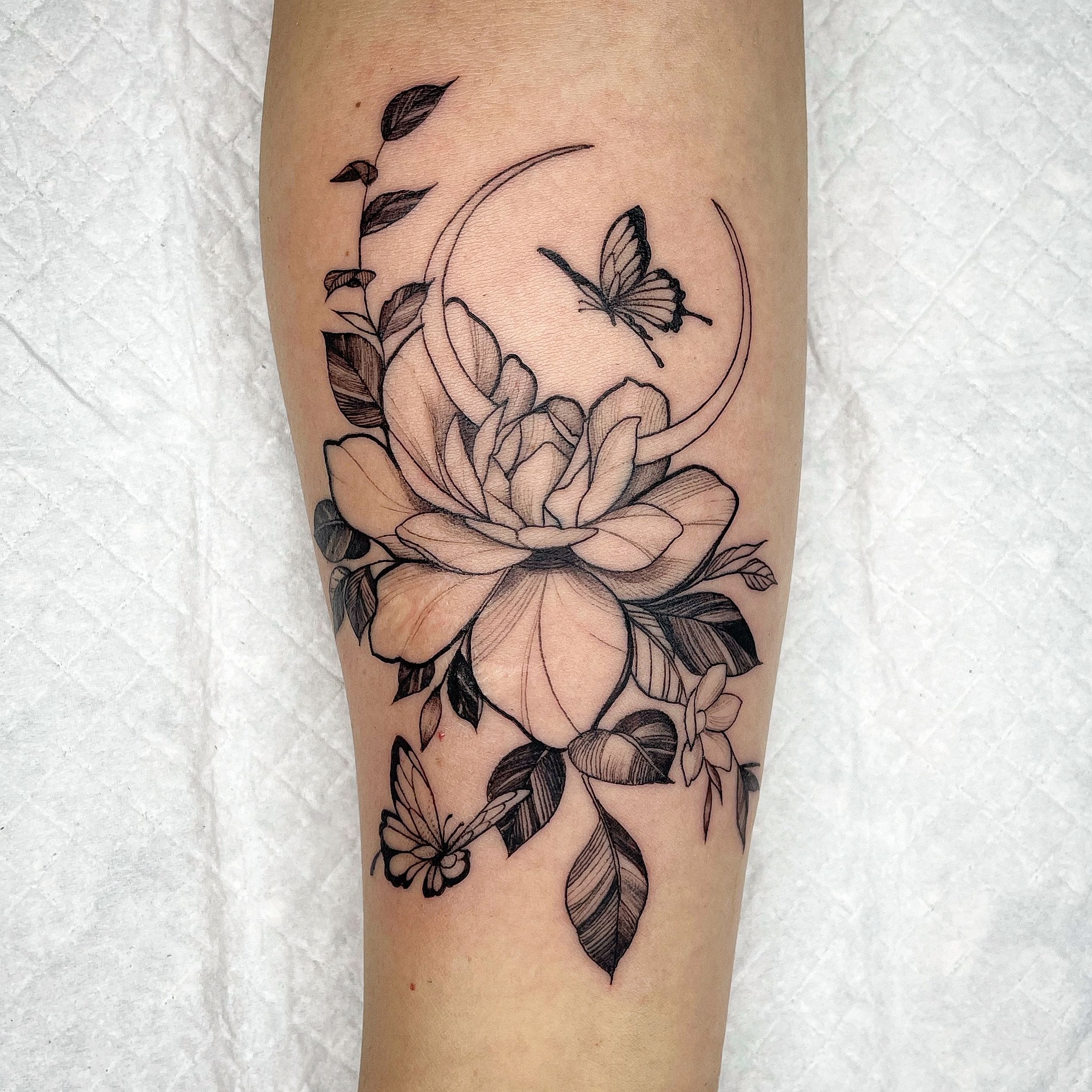 Flower Tattoo With Crescent Moon & Butterfly By Kawa at Iron Palm Tattoos In Atlanta. Kawa created this tattoo from a tattoo flash he designed. Call or text 404-973-7828 or stop by for a free consultation. Walk ins are welcome.